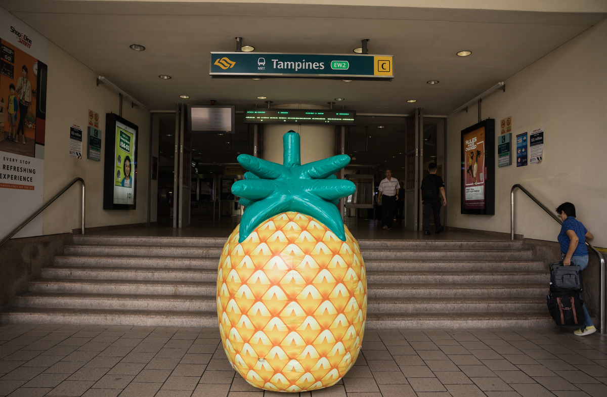 Caltex opens new station with giant pineapple rolling around Singapore city