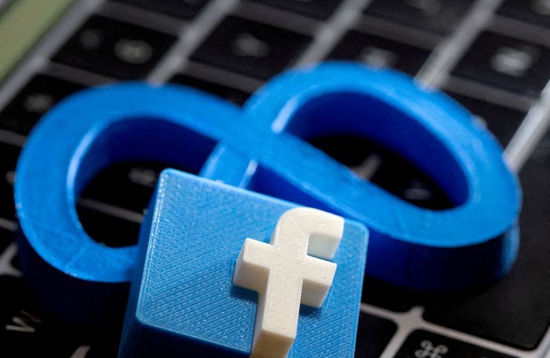 FILE PHOTO: 3D-printed images of the logos of Facebook and parent company Meta Platforms are seen on a laptop keyboard in this illustration