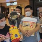 Young people carry buckets to cinema for free popcorn